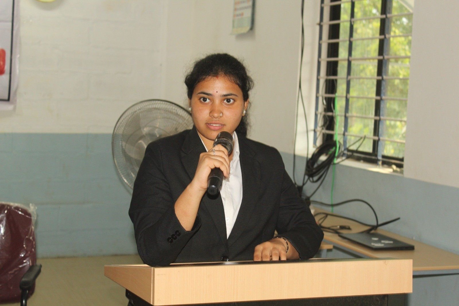 A student speaking at the podium